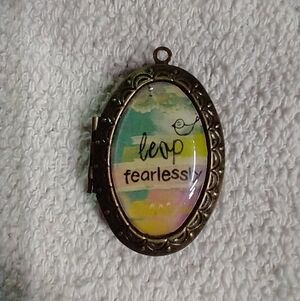 Bronze tone leap fearlessly bird locket pendant